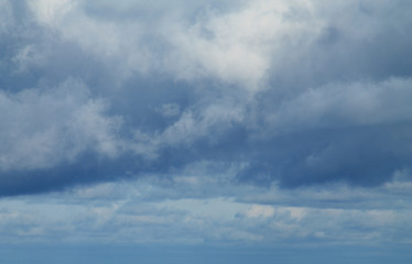 Overcast sky. Dark rain clouds. Blue, white and gray tones.
