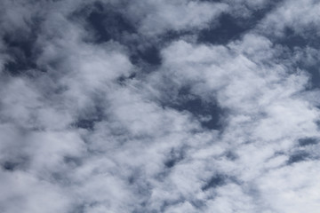 Obraz premium The movement of white light fluffy clouds in the blue sky.