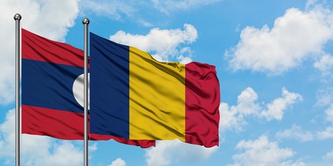 Laos and Chad flag waving in the wind against white cloudy blue sky together. Diplomacy concept, international relations.