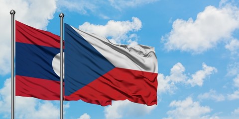 Laos and Czech Republic flag waving in the wind against white cloudy blue sky together. Diplomacy concept, international relations.