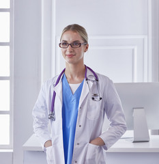 Portrait of a happy smiling young doctor in headset in office