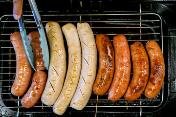 Grilled sausages on barbecue grill