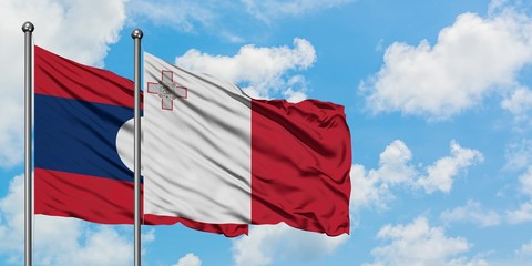 Laos and Malta flag waving in the wind against white cloudy blue sky together. Diplomacy concept, international relations.