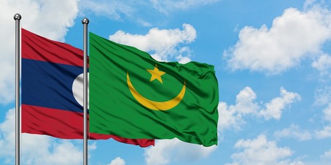 Laos and Mauritania flag waving in the wind against white cloudy blue sky together. Diplomacy concept, international relations.