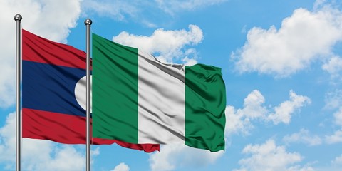 Laos and Nigeria flag waving in the wind against white cloudy blue sky together. Diplomacy concept, international relations.