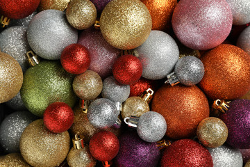 Multicolored Christmas balls textured background, top view