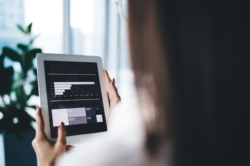 Businesswoman working with diagrams on tablet