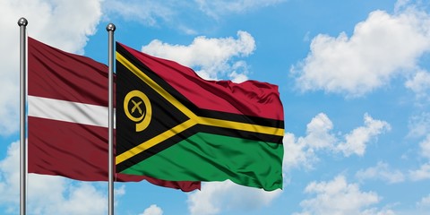 Latvia and Vanuatu flag waving in the wind against white cloudy blue sky together. Diplomacy concept, international relations.