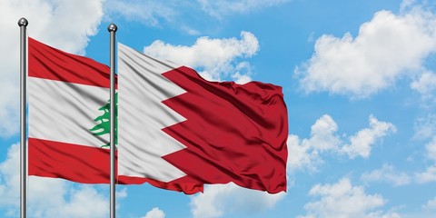 Lebanon and Bahrain flag waving in the wind against white cloudy blue sky together. Diplomacy concept, international relations.