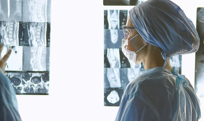 Two female women medical doctors looking at x-rays in a hospital