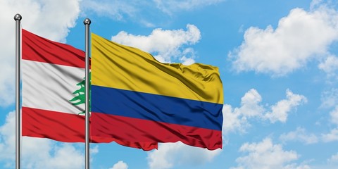 Lebanon and Colombia flag waving in the wind against white cloudy blue sky together. Diplomacy concept, international relations.