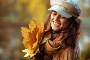 happy elegant woman with yellow leaves enjoy autumn time