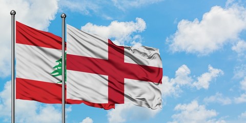 Lebanon and England flag waving in the wind against white cloudy blue sky together. Diplomacy concept, international relations.