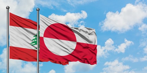Lebanon and Greenland flag waving in the wind against white cloudy blue sky together. Diplomacy concept, international relations.