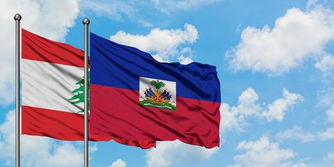 Lebanon and Haiti flag waving in the wind against white cloudy blue sky together. Diplomacy...