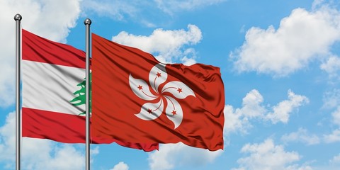 Lebanon and Hong Kong flag waving in the wind against white cloudy blue sky together. Diplomacy concept, international relations.