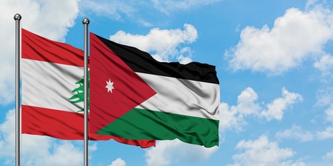 Lebanon and Jordan flag waving in the wind against white cloudy blue sky together. Diplomacy concept, international relations.