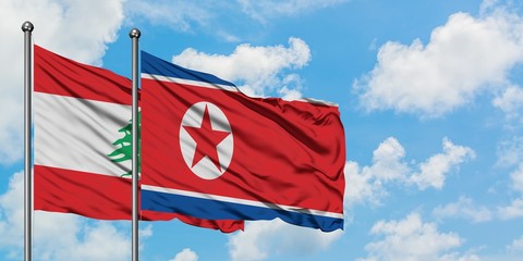 Lebanon and North Korea flag waving in the wind against white cloudy blue sky together. Diplomacy concept, international relations.