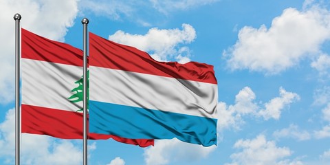 Lebanon and Luxembourg flag waving in the wind against white cloudy blue sky together. Diplomacy concept, international relations.