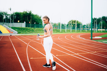 Fototapeta premium Athletic woman running on jogging path