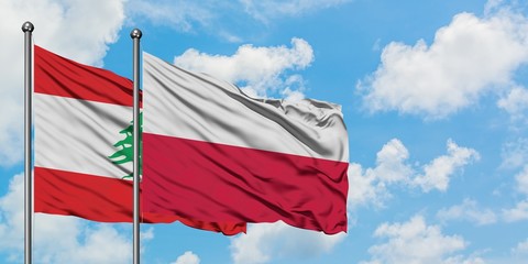 Lebanon and Poland flag waving in the wind against white cloudy blue sky together. Diplomacy concept, international relations.