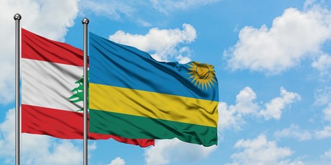 Lebanon and Rwanda flag waving in the wind against white cloudy blue sky together. Diplomacy concept, international relations.