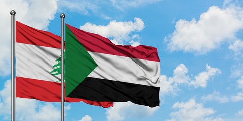 Lebanon and Sudan flag waving in the wind against white cloudy blue sky together. Diplomacy concept, international relations.