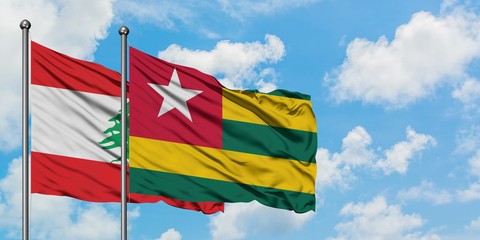 Lebanon and Togo flag waving in the wind against white cloudy blue sky together. Diplomacy concept, international relations.
