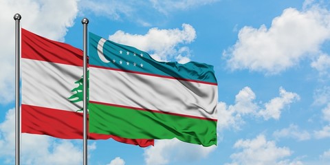 Lebanon and Uzbekistan flag waving in the wind against white cloudy blue sky together. Diplomacy concept, international relations.