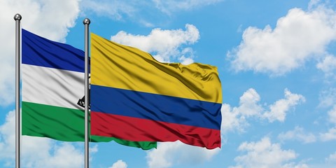 Lesotho and Colombia flag waving in the wind against white cloudy blue sky together. Diplomacy concept, international relations.