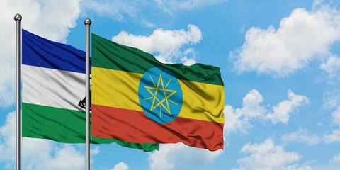 Lesotho and Ethiopia flag waving in the wind against white cloudy blue sky together. Diplomacy concept, international relations.