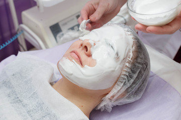 A cosmetologist does an ultrasonic cleaning of the skin of the face.