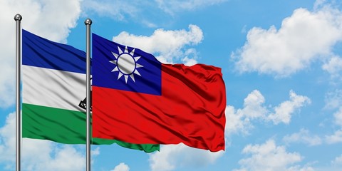 Lesotho and Taiwan flag waving in the wind against white cloudy blue sky together. Diplomacy concept, international relations.