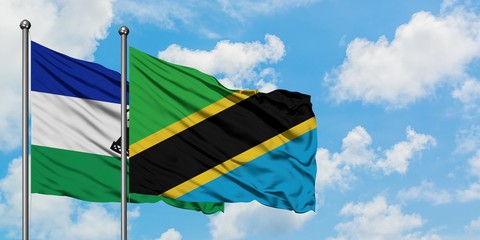 Lesotho and Tanzania flag waving in the wind against white cloudy blue sky together. Diplomacy concept, international relations.