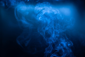 Fototapeta na wymiar Smoke movements background in low blue light