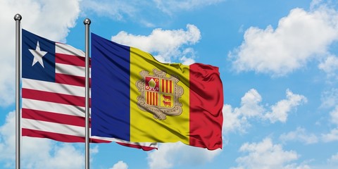 Liberia and Andorra flag waving in the wind against white cloudy blue sky together. Diplomacy concept, international relations.