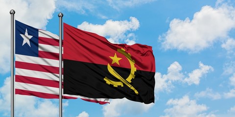 Liberia and Angola flag waving in the wind against white cloudy blue sky together. Diplomacy concept, international relations.