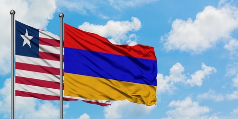 Liberia and Armenia flag waving in the wind against white cloudy blue sky together. Diplomacy concept, international relations.