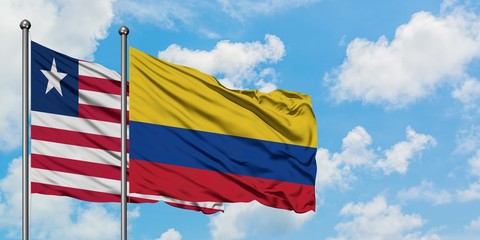 Liberia and Colombia flag waving in the wind against white cloudy blue sky together. Diplomacy concept, international relations.