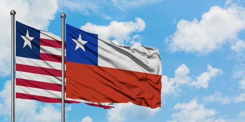 Liberia and Chile flag waving in the wind against white cloudy blue sky together. Diplomacy concept, international relations.