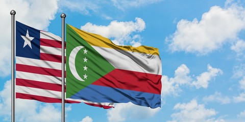 Liberia and Comoros flag waving in the wind against white cloudy blue sky together. Diplomacy concept, international relations.