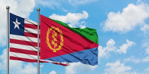 Liberia and Eritrea flag waving in the wind against white cloudy blue sky together. Diplomacy concept, international relations.
