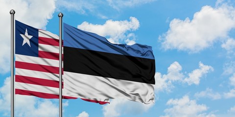 Liberia and Estonia flag waving in the wind against white cloudy blue sky together. Diplomacy concept, international relations.
