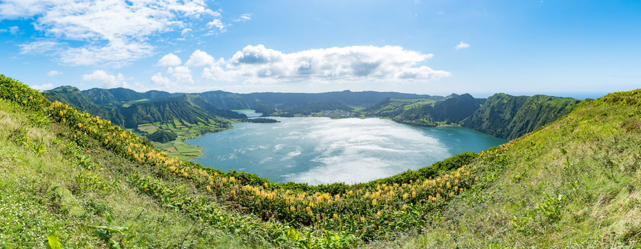 Panorama of the volcanic caldera at Sete Cidades on São Miguel in the Azores. The Azul and Verde lakes show their blue and green waters with Yellow Ginger (Hedychium gardnerianum) in the foreground.