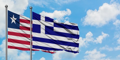 Liberia and Greece flag waving in the wind against white cloudy blue sky together. Diplomacy concept, international relations.
