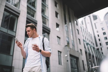 Fototapeta premium Man using mobile phone on street