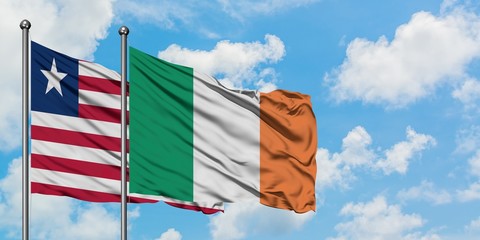 Liberia and Ireland flag waving in the wind against white cloudy blue sky together. Diplomacy concept, international relations.