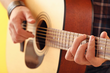 Handsome man playing guitar, closeup