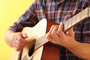 Fototapeta premium Handsome man playing guitar, closeup