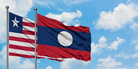 Liberia and Laos flag waving in the wind against white cloudy blue sky together. Diplomacy concept, international relations.